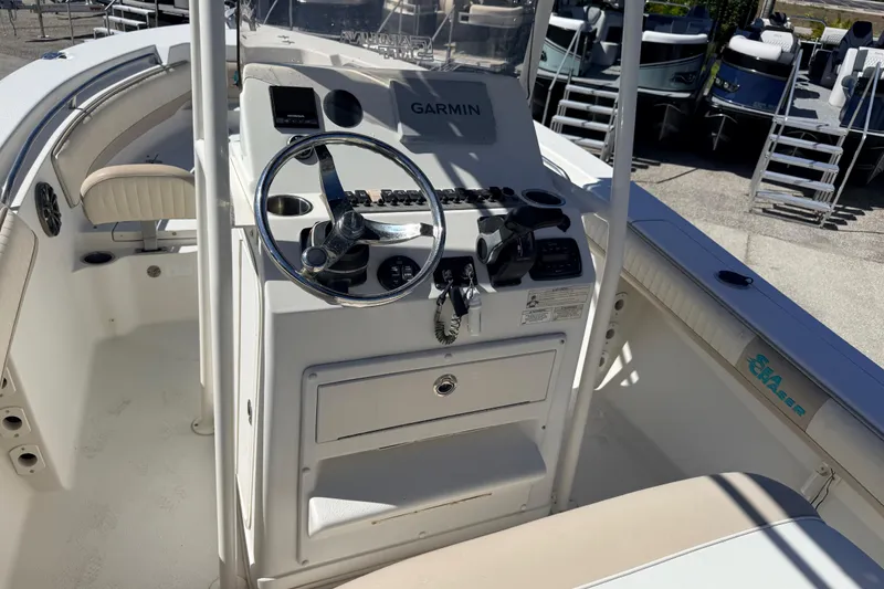 Slide: The Image of 2015 Sea Chaser 22 HFC boat cockpit with Garmin navigation system and steering wheel. - 25