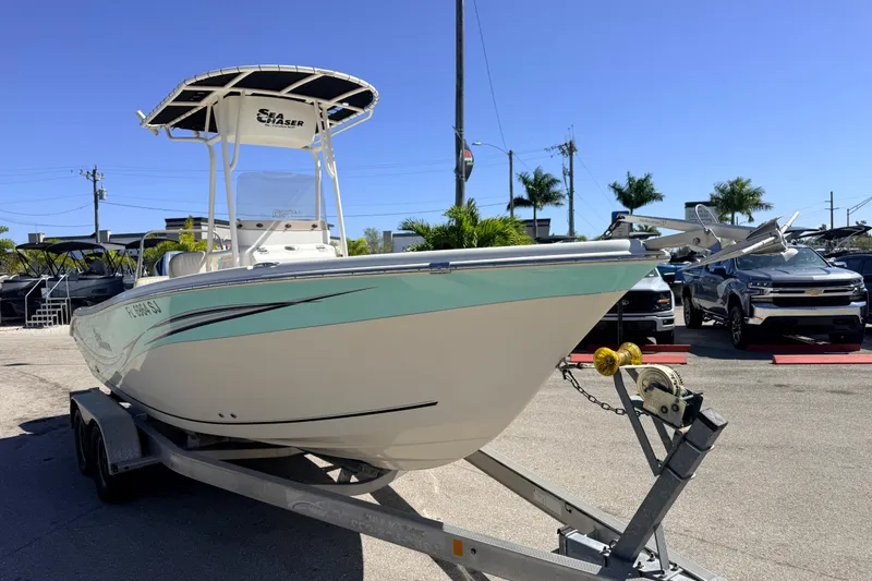 Slide: The Image of 2015 Sea Chaser 22 HFC boat on trailer, parked outdoors under clear blue sky. - 5