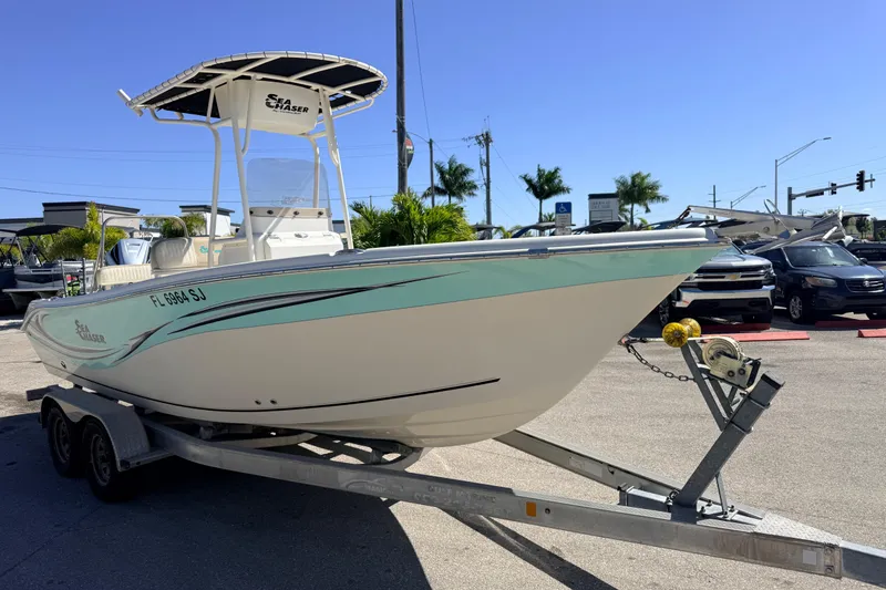 Slide: The Image of 2015 Sea Chaser 22 HFC boat on trailer, parked outdoors under clear blue sky. - 6