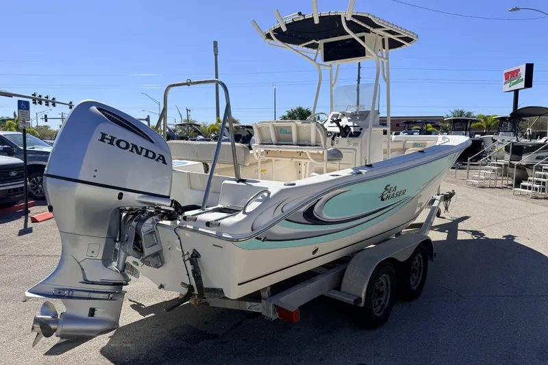 Slide: The Image of 2015 Sea Chaser 22 HFC boat with Honda outboard motor on trailer in sunny dealership lot. - 8