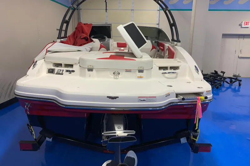 Slide: The Image of 2017 Chaparral 21 H2O Sport boat in showroom, featuring red and white interior. - 3