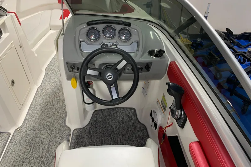Slide: The Image of 2017 Chaparral 21 H2O Sport boat cockpit with steering wheel and control panel. - 4