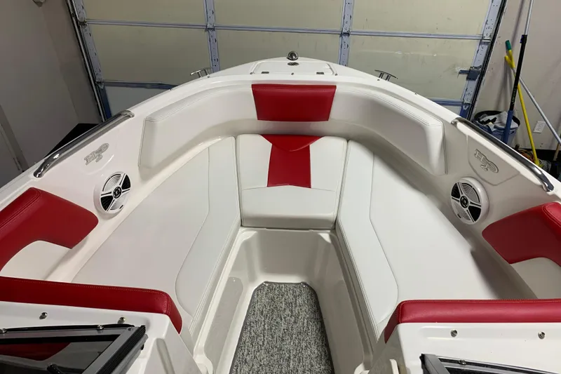 Slide: The Image of 2017 Chaparral 21 H2O Sport boat interior with red and white seating, speakers, and carpeted floor. - 7