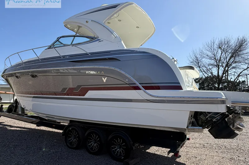 The Image of 2018 Formula 34 Performance Cruiser boat on trailer, side view under clear sky. - 0