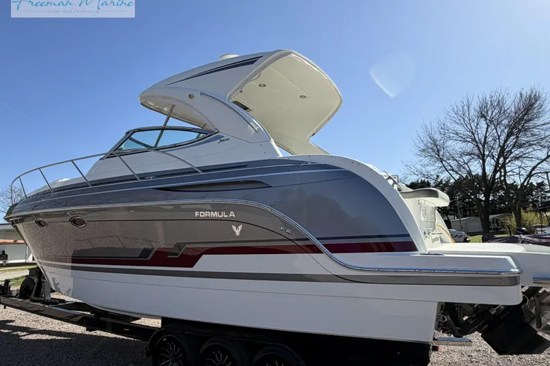 Slide: The Image of 2018 Formula 34 Performance Cruiser boat on trailer, side view under clear blue sky. - 11
