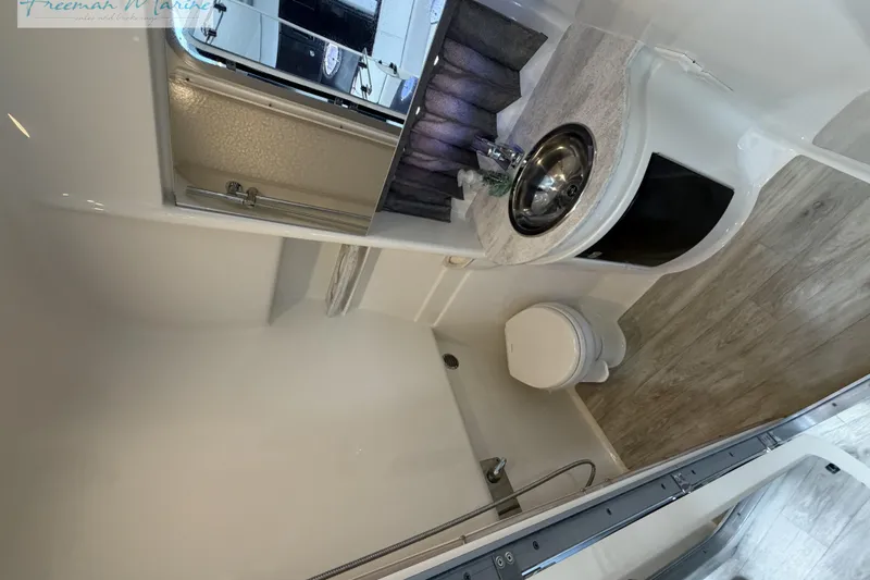Slide: The Image of 2018 Formula 34 Performance Cruiser bathroom with sink, toilet, and shower. - 34