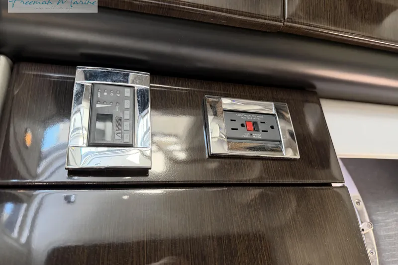 Slide: The Image of Control panel and outlet on 2018 Formula 34 Performance Cruiser interior. - 35