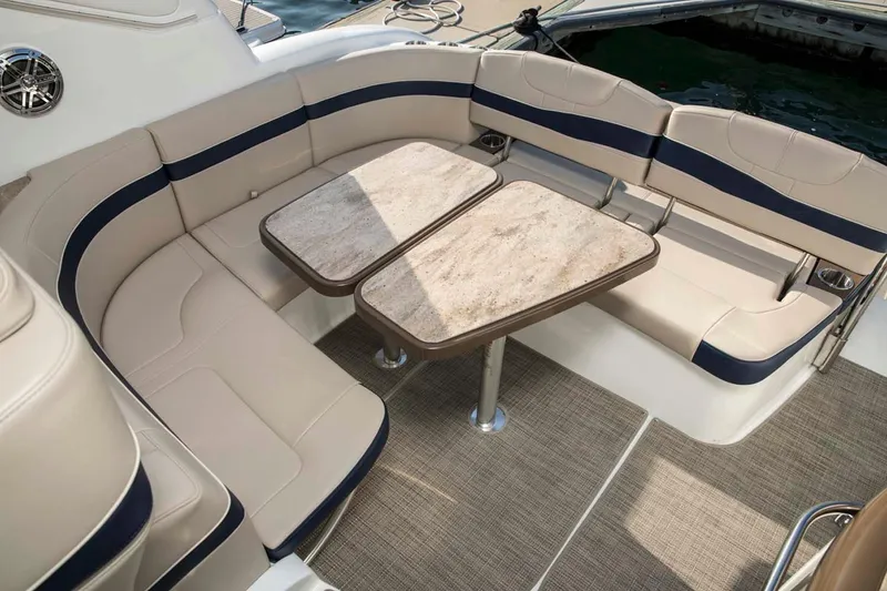 Slide: The Image of Manufacturer Provided Image: 2018 Formula 34 Cruiser boat seating area with dual tables and beige upholstery. - 38