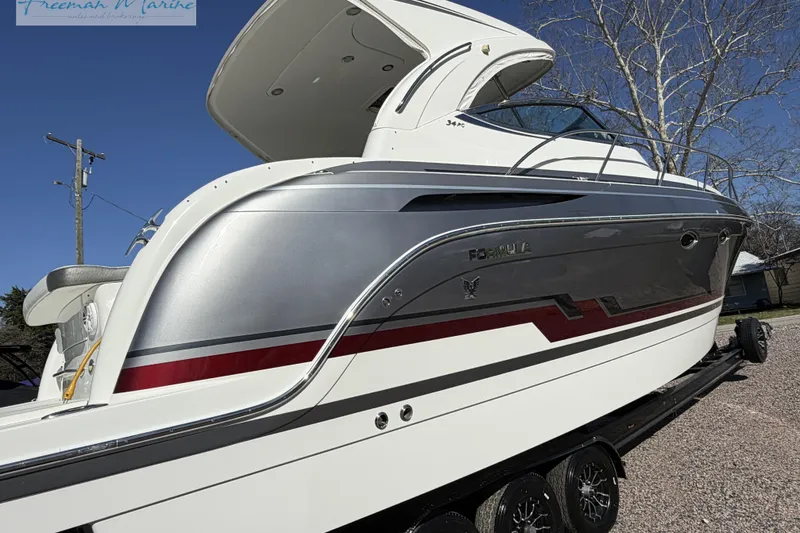 Slide: The Image of 2018 Formula 34 Performance Cruiser boat on trailer, sleek design, silver and white exterior. - 6