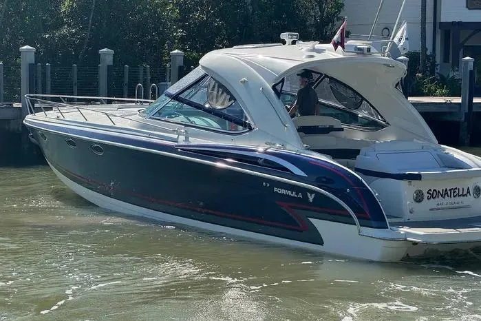 Slide: The Image of 2017 Formula 400 Super Sport boat docked in sunny marina setting. - 10