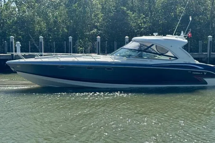 Slide: The Image of 2017 Formula 400 Super Sport boat docked on calm water. - 11