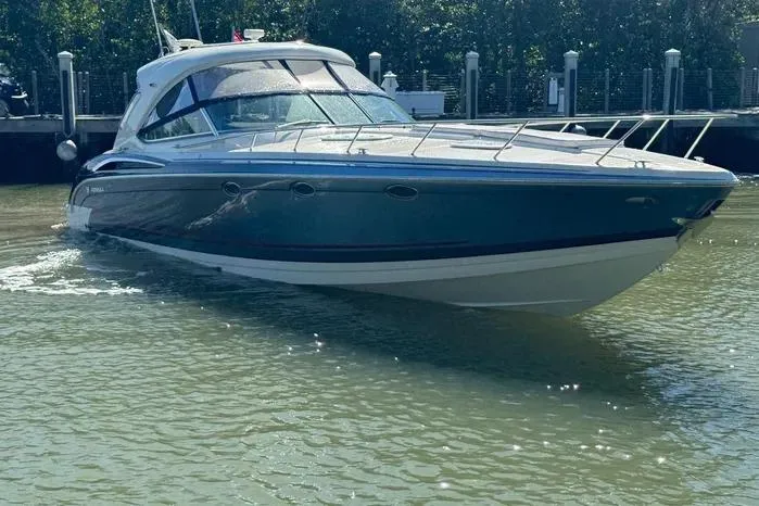 Slide: The Image of 2017 Formula 400 Super Sport boat docked in calm waters, showcasing sleek design and luxury features. - 12