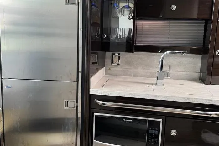 Slide: The Image of Modern kitchen area in a 2017 Formula 400 Super Sport yacht, featuring stainless steel appliances. - 17
