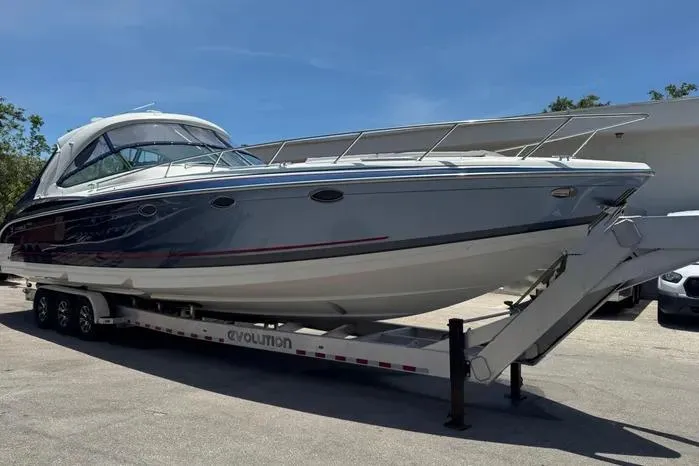 Slide: The Image of 2017 Formula 400 Super Sport boat on trailer, parked outdoors under clear sky. - 3