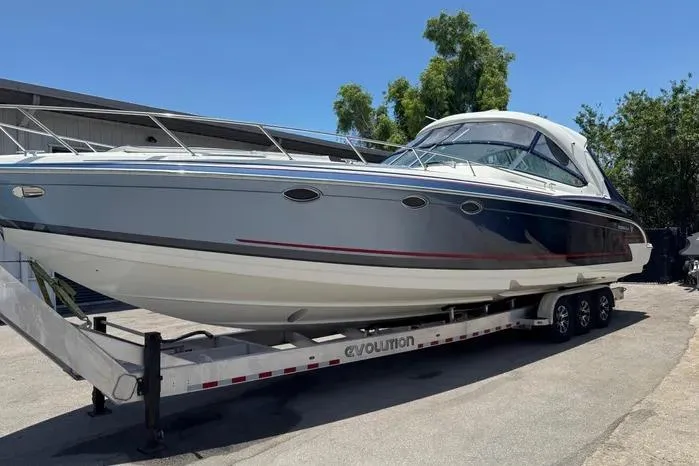 Slide: The Image of 2017 Formula 400 Super Sport boat on trailer, sleek design, parked outdoors. - 4