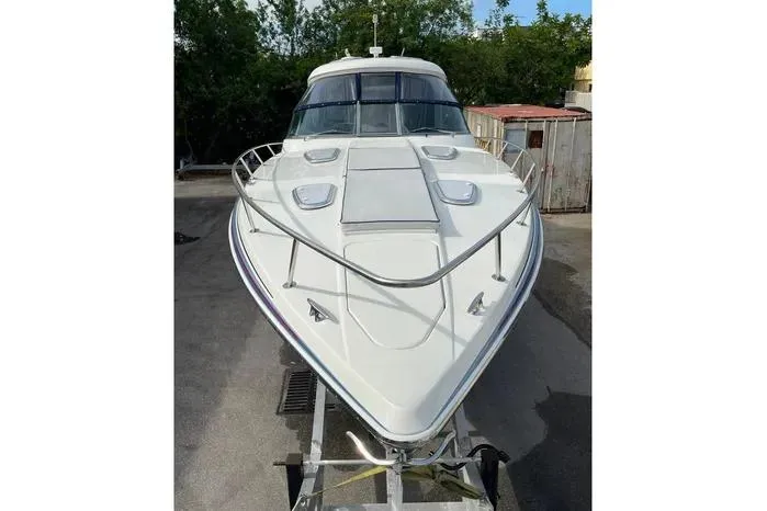 Slide: The Image of 2017 Formula 400 Super Sport boat on trailer, front view, outdoors. - 7