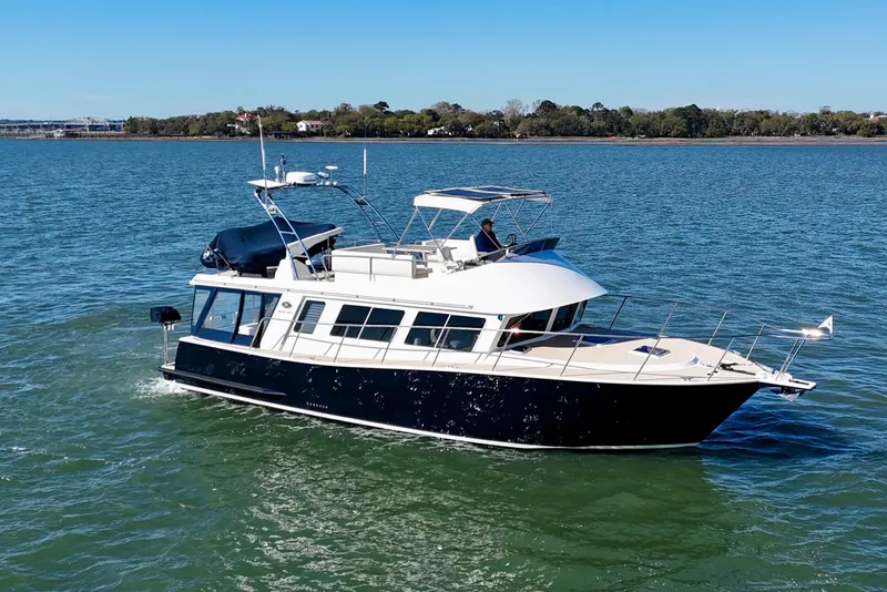 Slide: The Image of 2015 Coastal Craft 45 yacht cruising on a serene blue waterway. - 1