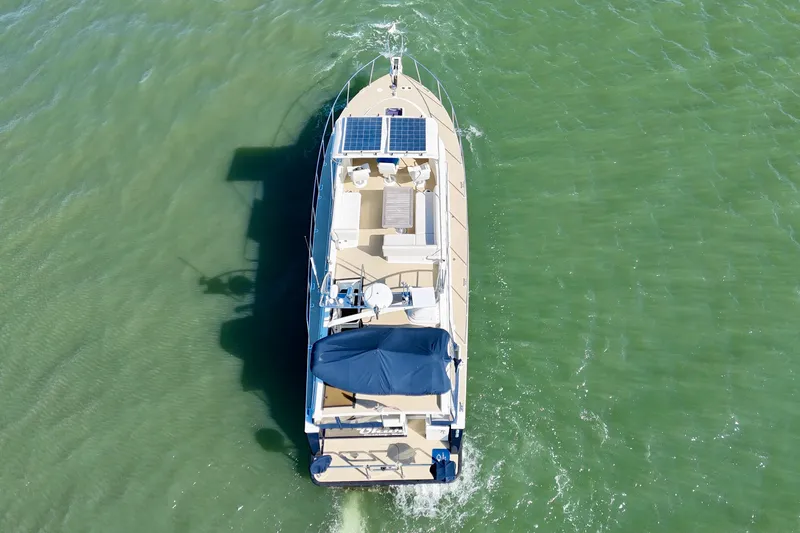 Slide: The Image of Aerial view of 2015 Coastal Craft 45 yacht cruising on green water. - 10