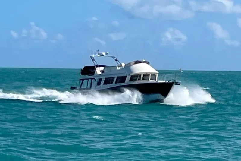 Slide: The Image of 2015 Coastal Craft 45 yacht cruising on turquoise ocean waters under a clear sky. - 11