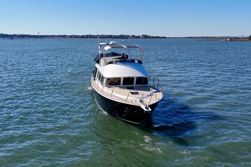Slide: The Image of 2015 Coastal Craft 45 yacht cruising on open water under clear blue skies. - 3