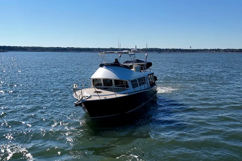 Slide: The Image of 2015 Coastal Craft 45 yacht cruising on a sunny day in open waters. - 4