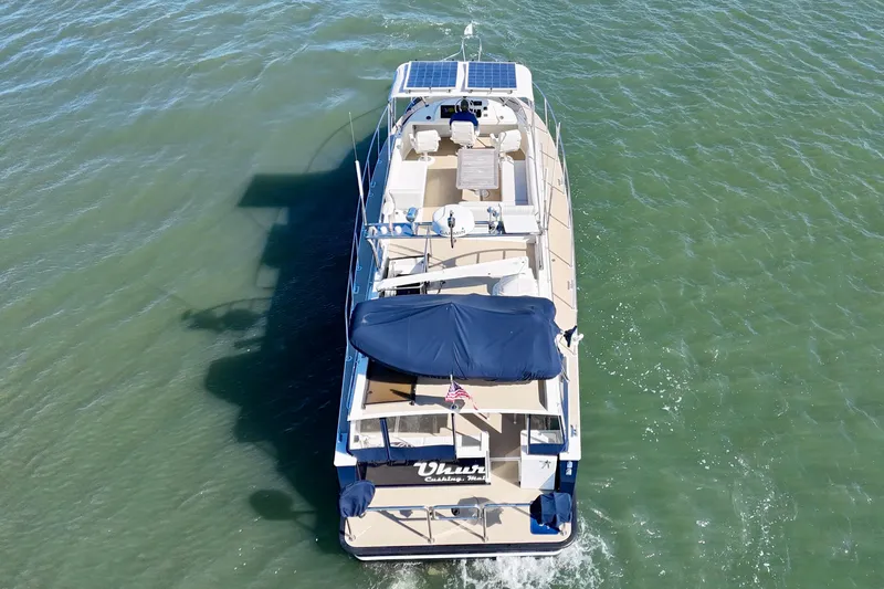 Slide: The Image of Aerial view of 2015 Coastal Craft 45 yacht cruising on open water. - 9