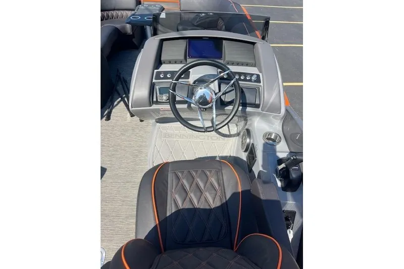 Slide: The Image of 2024 Bennington 23 RXFBA boat dashboard with steering wheel and control panel. - 11