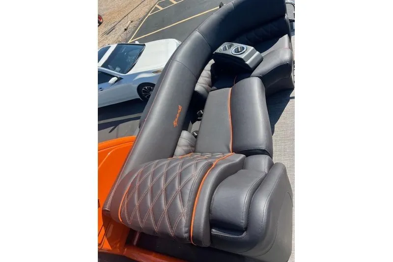 Slide: The Image of Luxurious seating on 2024 Bennington 23 RXFBA boat with orange accents and cup holders. - 5