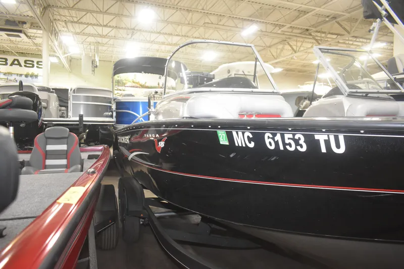 Slide: The Image of 2015 Tracker Targa 18 WT boat displayed indoors, showcasing sleek black design. - 4