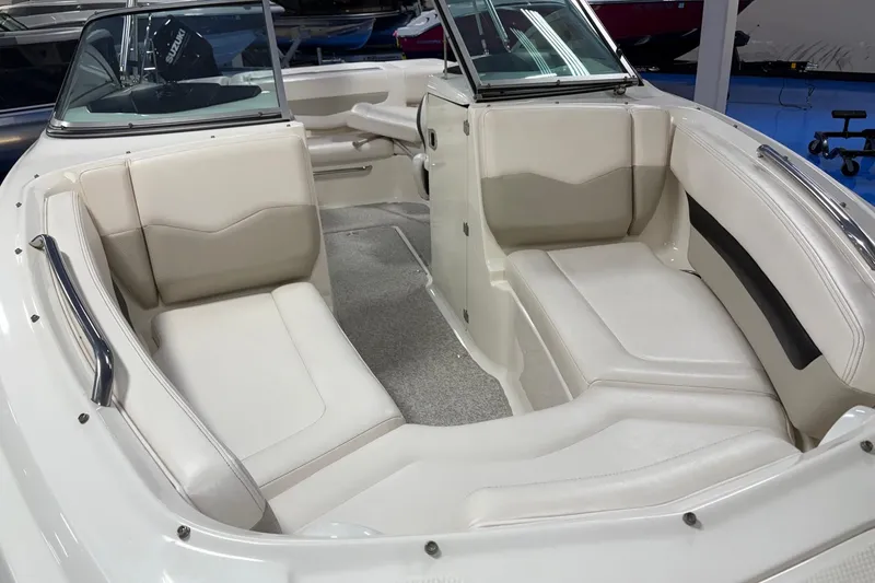 Slide: The Image of 2011 Chaparral 216 SSi boat interior with white seating and sleek design. - 4