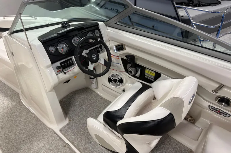 Slide: The Image of 2011 Chaparral 216 SSi boat interior with steering wheel and dashboard controls. - 5