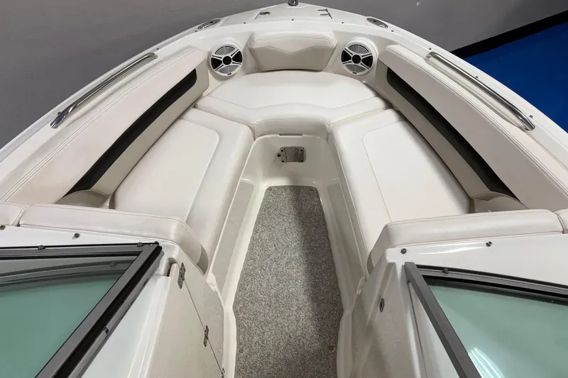 Slide: The Image of 2011 Chaparral 216 SSi boat interior with white seating and speakers. - 7