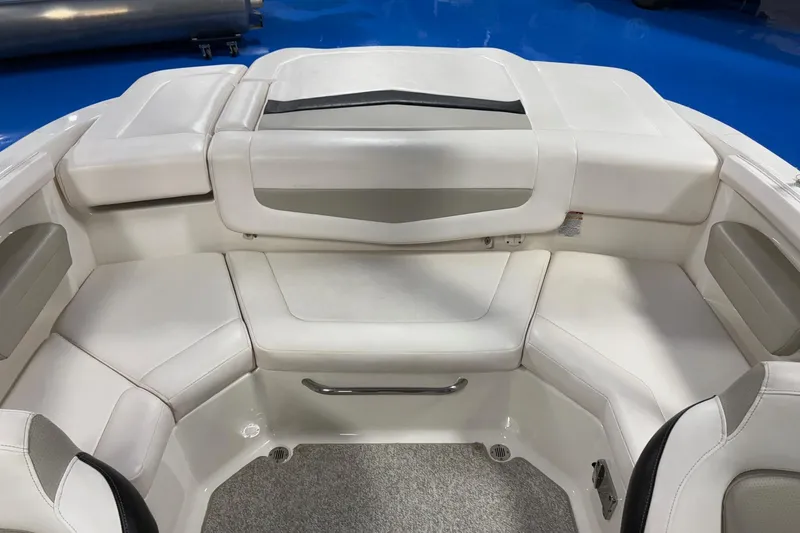 Slide: The Image of Interior seating of a 2011 Chaparral 216 SSi boat, featuring white upholstery. - 9