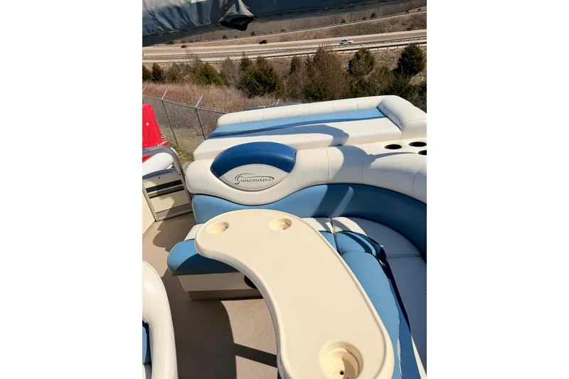 Slide: The Image of 2004 Lowe Jamaica 250 boat interior with blue and white seating and table. - 13