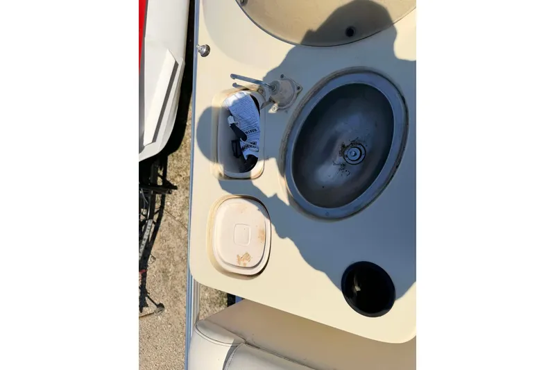 Slide: The Image of 2004 Lowe Jamaica 250 boat sink area with faucet and storage compartments. - 4