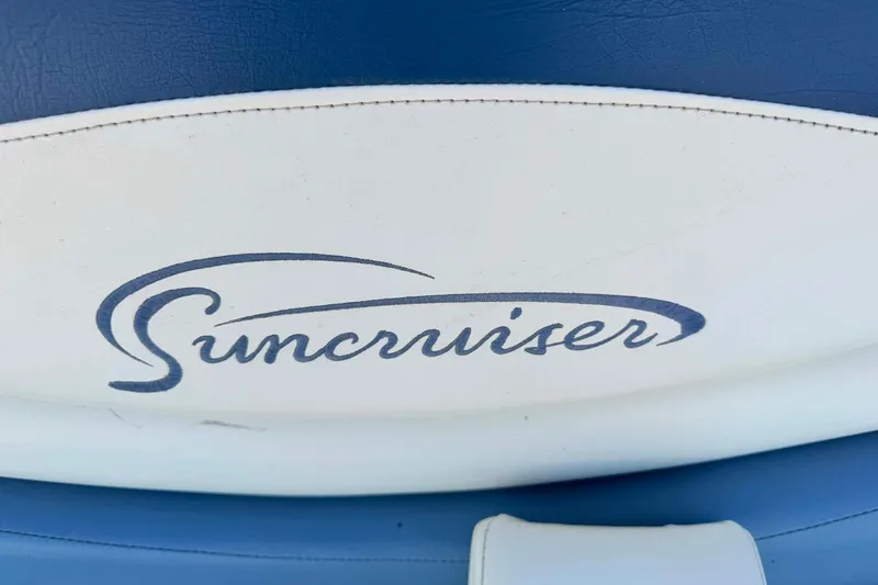 Slide: The Image of Suncruiser logo on 2004 Lowe Jamaica 250 boat seat, blue and white design. - 7