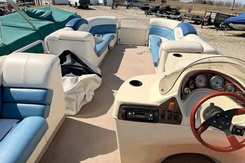 Slide: The Image of 2004 Lowe Jamaica 250 boat interior with blue and white seating, steering console, and dashboard. - 8