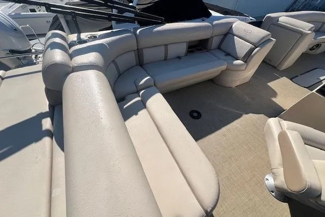 Slide: The Image of 2019 Harris Cruiser 250 boat with beige seating and cup holders on deck. - 10