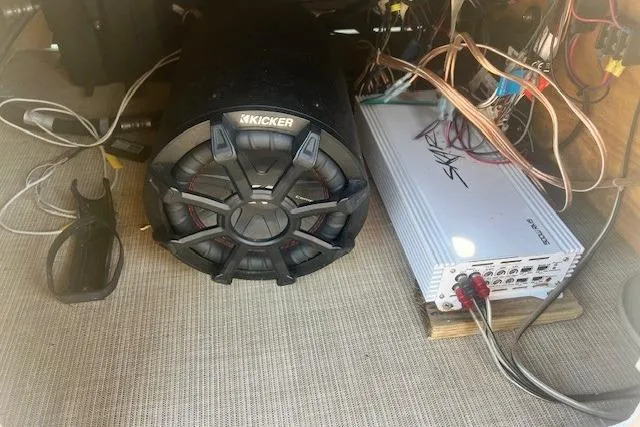 Slide: The Image of 2019 Harris Cruiser 250 boat interior with beige seating and cup holders. - 12