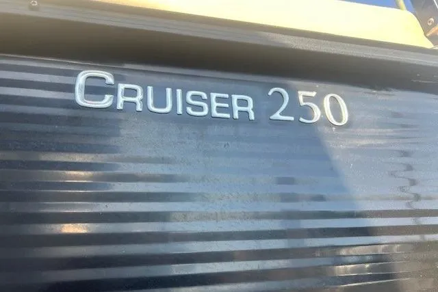 Slide: The Image of 2019 Harris Cruiser 250 boat interior with helm and seating area. - 15