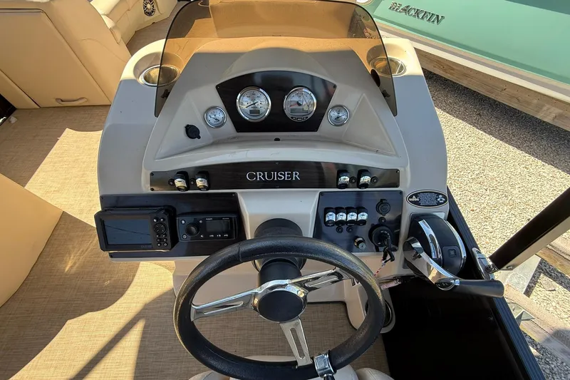 Slide: The Image of 2019 Harris Cruiser 250 dashboard with steering wheel and control panel. - 16