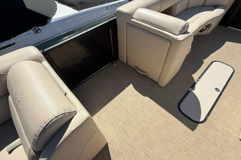 Slide: The Image of 2019 Harris Cruiser 250 boat interior with beige seating and flooring. - 18