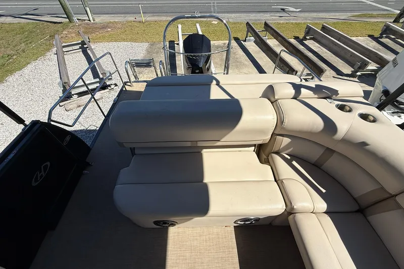 Slide: The Image of 2019 Harris Cruiser 250 boat interior with beige seating and cup holders. - 21