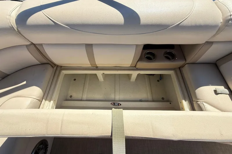 Slide: The Image of Interior storage compartment of a 2019 Harris Cruiser 250 boat with beige seating. - 22