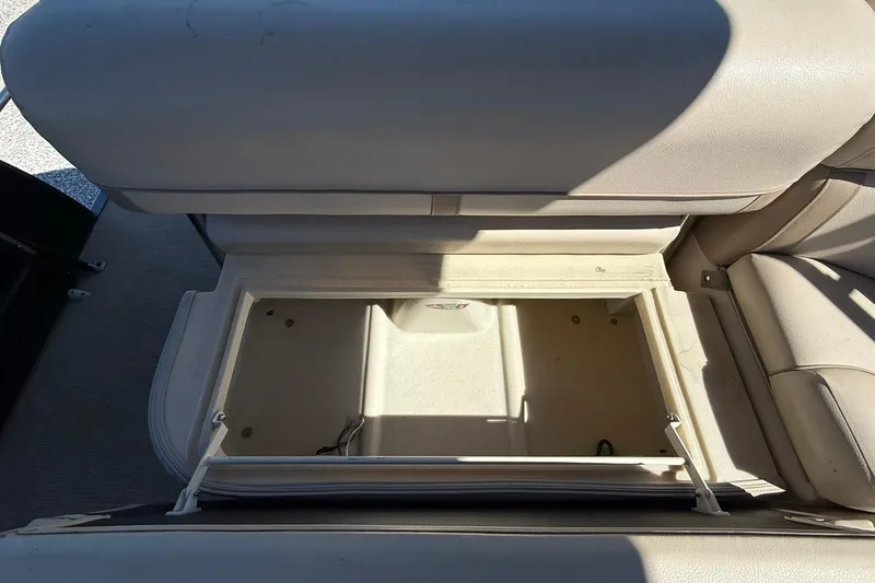 Slide: The Image of Open storage compartment in 2019 Harris Cruiser 250 boat seat. - 23