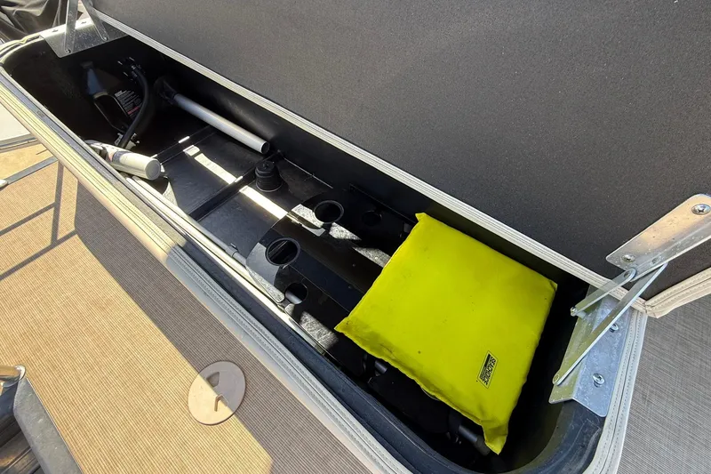 Slide: The Image of Storage compartment of a 2019 Harris Cruiser 250 boat with yellow cushion and accessories. - 25