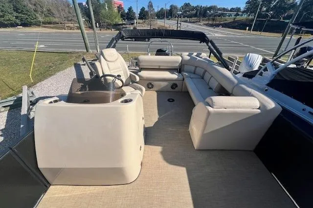 Slide: The Image of 2019 Harris Cruiser 250 boat with beige seating and storage compartment. - 6