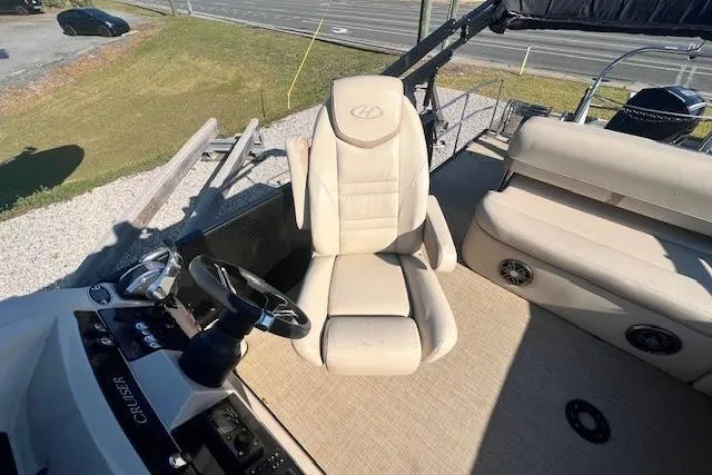 Slide: The Image of 2019 Harris Cruiser 250 boat seat storage compartment open, revealing interior space. - 7
