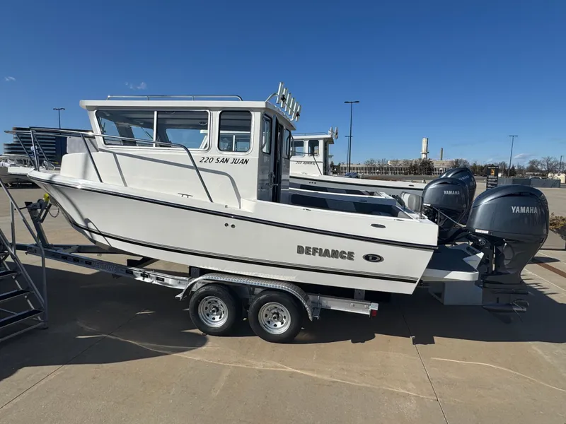 The Image of 2025 Defiance San Juan 220 boat on trailer with Yamaha engines, parked outdoors. - 17