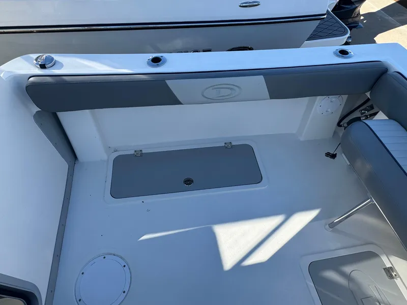 Slide: The Image of 2025 Defiance San Juan 220 boat interior with seating and storage compartments. - 21